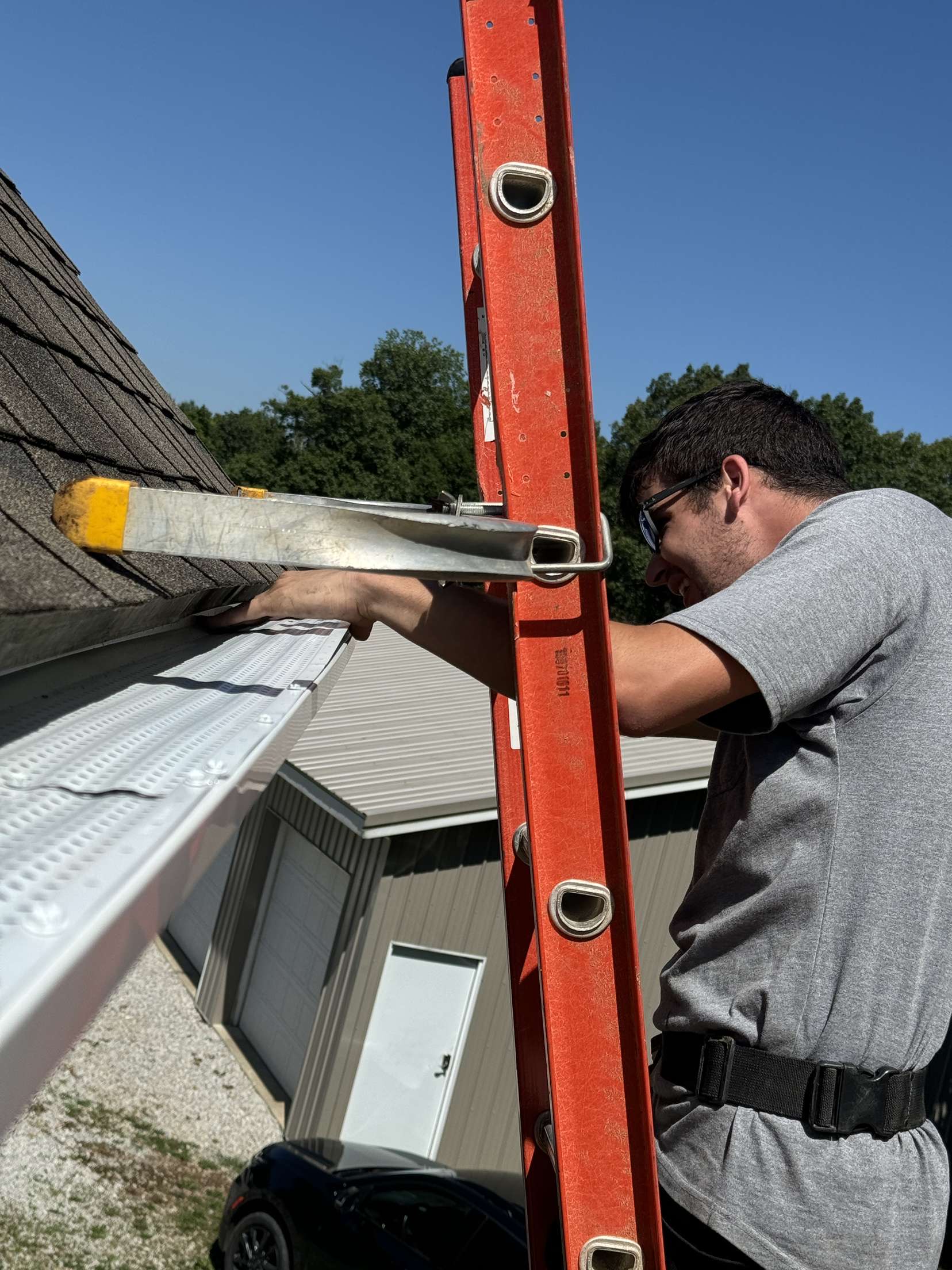Technician installing leaf protection on a gutter